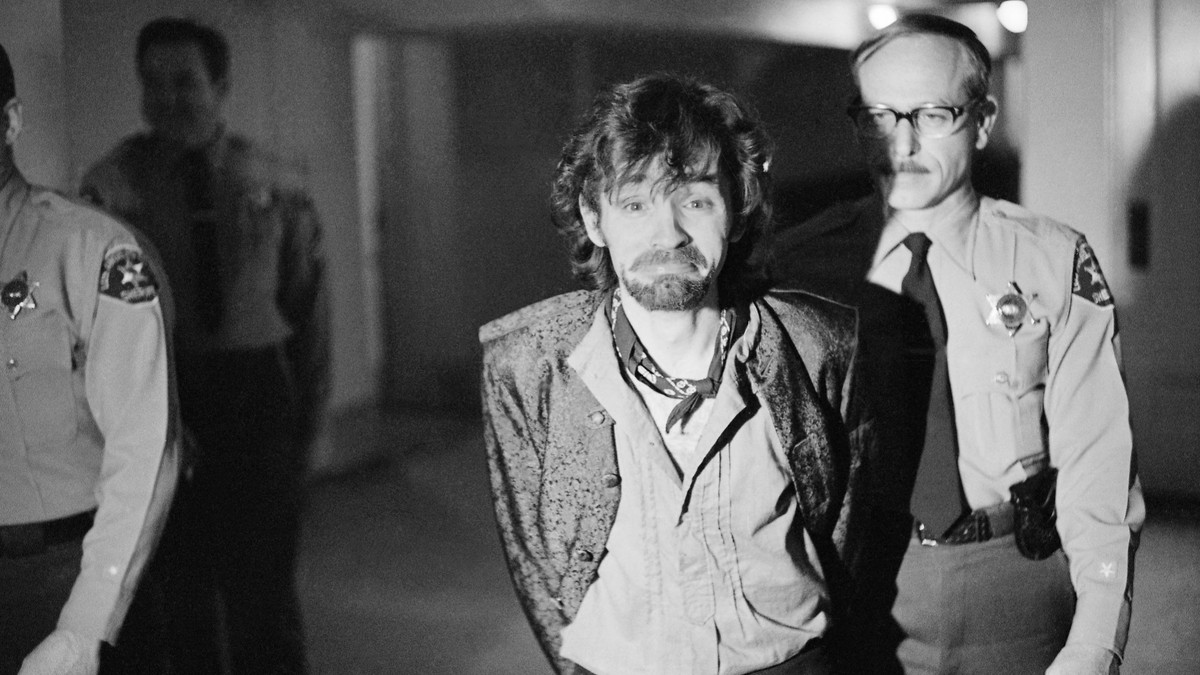 FILE - In this Dec. 21, 1970 file photo, Charles Manson reacts to photographers as he goes to lunch after an outbreak in court that resulted in his ejection, along with three female co-defendants, in  ...