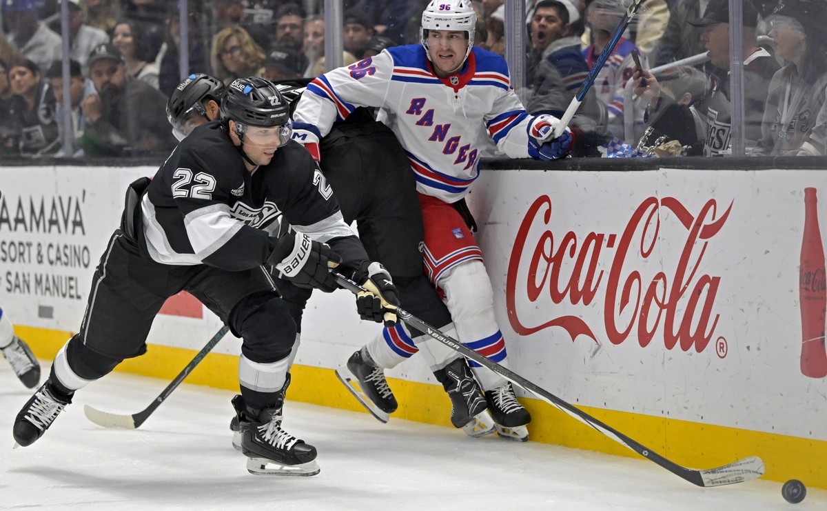 New York Rangers right wing Nicolas Aube-Kubel (96) is pinned along the boards as Los Angeles Kings left wing Kevin Fiala reaches for the puck during the second period of an NHL hockey game Tuesday, M ...