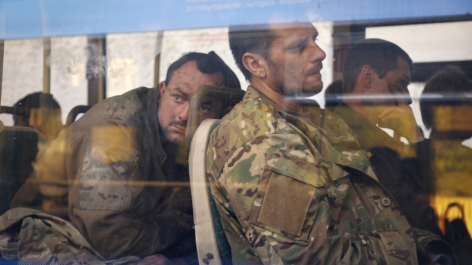 Ukrainian servicemen sit in a bus after they were evacuated from the besieged Mariupol&#039;s Azovstal steel plant, near a remand prison in Olyonivka, in territory under the government of the Donetsk  ...