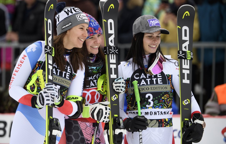 epa06576674 Winner Tina Weirather, center, of Liechtenstein, second placed Anna Veith, right, of Austria and third placed Wendy Holdener, left, of Switzerland celebrate during the podium ceremony afte ...