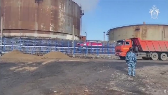 epa08465320 A still image taken from a handout video footage made available 04 June 2020 by the Russian Investigative Committee shows investigators and rescues working at the site of the accident at a ...