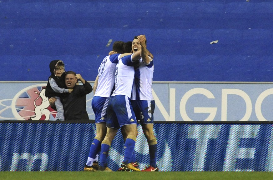 Wigan&#039;s Will Grigg celebrates with his teammates after scoring his side&#039;s opening goal during the English FA Cup fifth round soccer match between Wigan Athletic and Manchester City at The DW ...