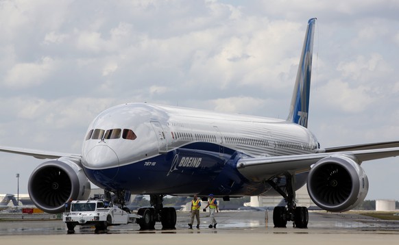 FILE - Boeing employees walk the new Boeing 787-10 Dreamliner down towards the delivery ramp area at the company&#039;s facility after conducting its first test flight at Charleston International Airp ...