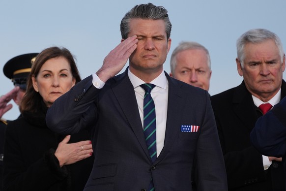 Defense Secretary Pete Hegseth salutes during a casualty return for Iowa National Guard soldiers Sgt. William Nathaniel Howard, 29, of Marshalltown, Iowa, and Sgt. Edgar Brian Torres-Tovar, 25, of Des ...