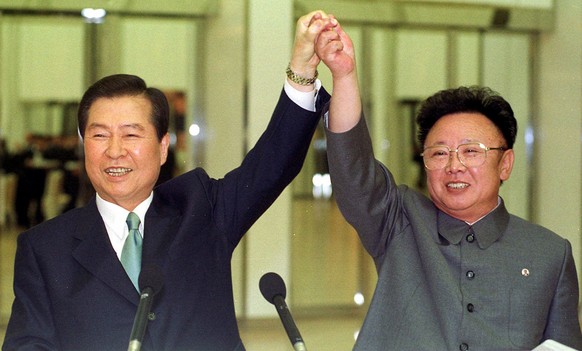 FILE - In this June 14, 2000, file photo, then North Korean leader Kim Jong Il, right, and then South Korean President Kim Dae-jung raise their arms together before signing a joint declaration at the  ...
