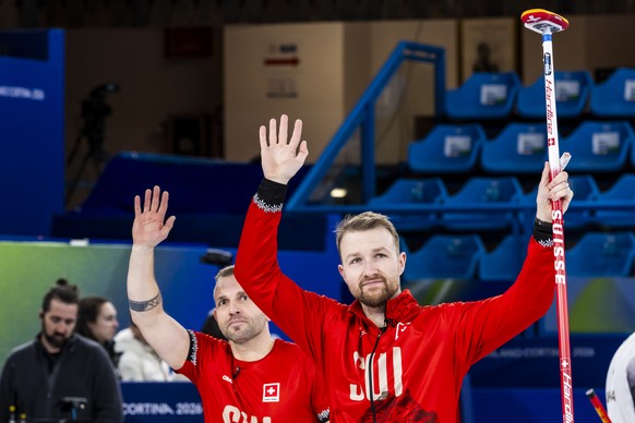 KEYPIX - Sven Michel and Yannick Schwaller of Switzerland, from left to right, celebrate during the men's curling round robin game between Switzerland and Sweden at the 2026 Olympic Winter Games  ...