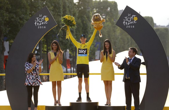 2016 Tour de France winner Chris Froome of Britain celebrates on the podium after the twenty-first and last stage of the Tour de France cycling race over 113 kilometers (70.2 miles) with start in Chan ...