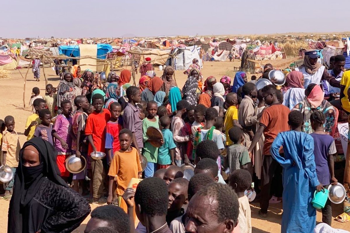 This photo released by The Norwegian Refugee Council (NRC), shows displaced families from el-Fasher at a displacement camp where they sought refuge from fighting between government forces and the RSF, ...
