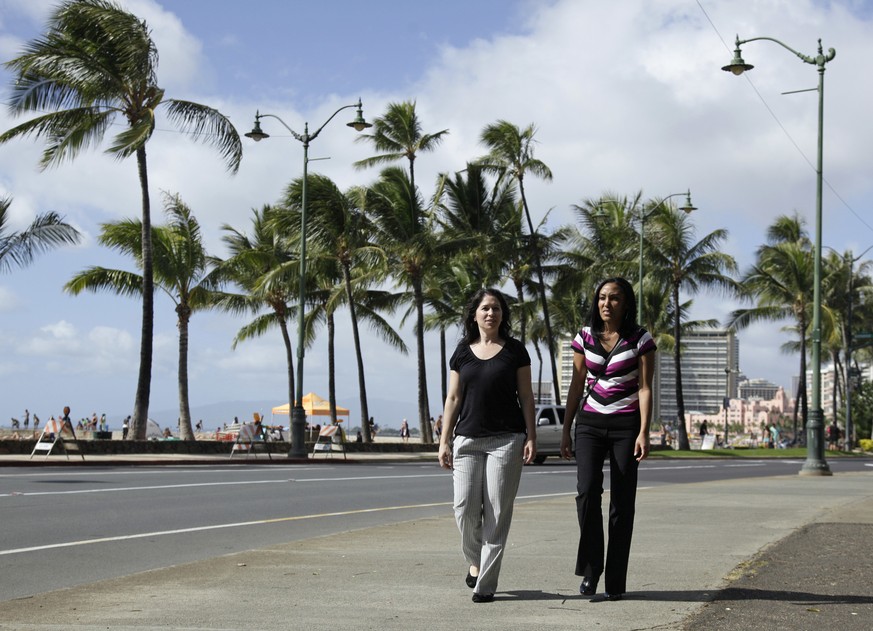 FILE - In this Dec. 19, 2011 file photo, Diane Cervelli, left, and Taeko Bufford, right, and walk past Waikiki beach in Honolulu. A Hawaii appeals court has ruled against a Hawaii bed and breakfast th ...