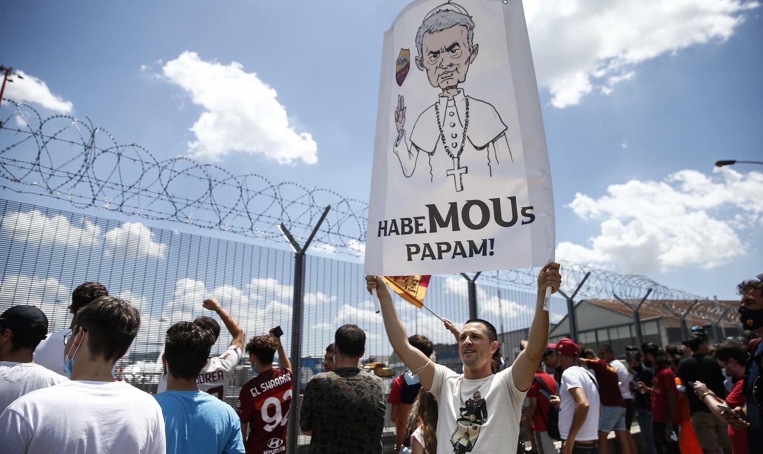 AS Roma fans wait outside Rome&#039;s Ciampino airport for the arrival of the new coach Jose Mourinho Friday, July 2, 2021. The banner reads: &quot;Habemous papam&quot;, joking with the words of the a ...