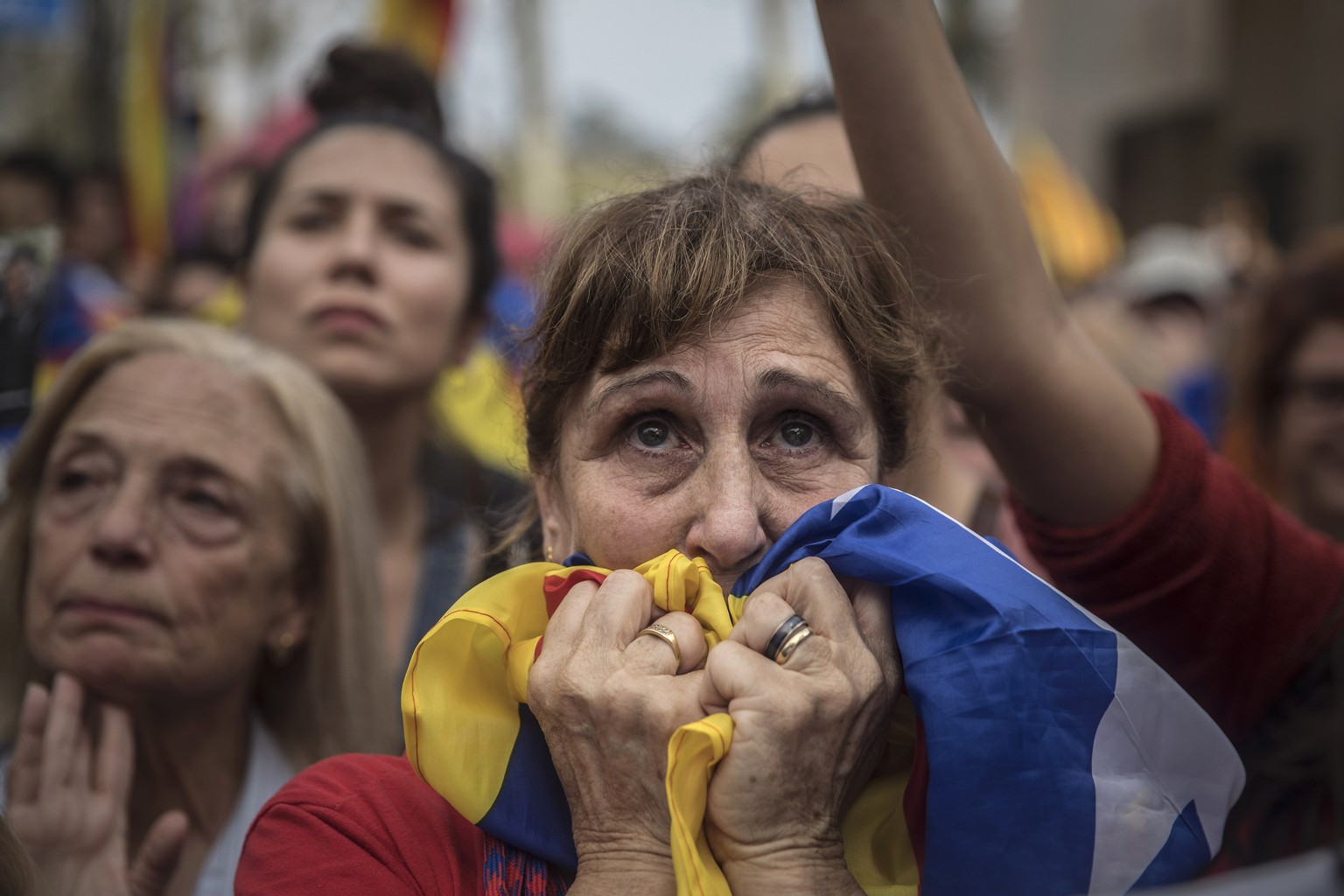 People react as they watch the parliament session on a huge screen during a rally outside the Catalan parliament in Barcelona, Spain, Friday, Oct. 27, 2017. Catalonia&#039;s regional parliament has pa ...