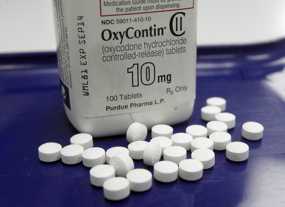 FILE - This Feb. 19, 2013, file photo, shows OxyContin pills arranged for a photo at a pharmacy in Montpelier, Vt. Two-thirds of the respondents in a Yahoo/Marist poll released Monday, April 17, 2017, ...