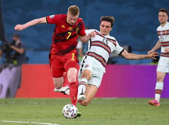 Belgium&#039;s Kevin De Bruyne, left, is fouled by Portugal&#039;s Joao Palhinha during the Euro 2020 soccer championship round of 16 match between Belgium and Portugal at La Cartuja stadium, Seville, ...