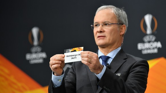 epa08883473 A handout photo made available by UEFA shows UEFA Deputy General Secretary Giorgio Marchetti draws out the card of Wolfsberger AC during the UEFA Europa League 2020/21 Round of 32 draw at  ...