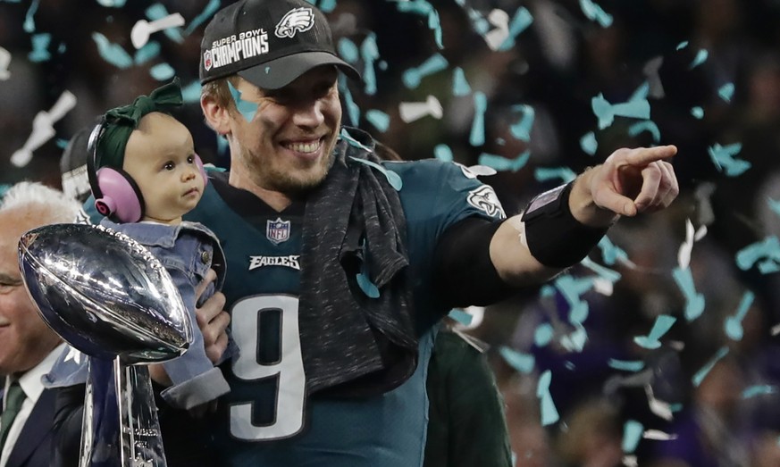 Philadelphia Eagles quarterback Nick Foles (9) holds his daughter, Lily James, after winning the NFL Super Bowl 52 football game against the New England Patriots, Sunday, Feb. 4, 2018, in Minneapolis. ...