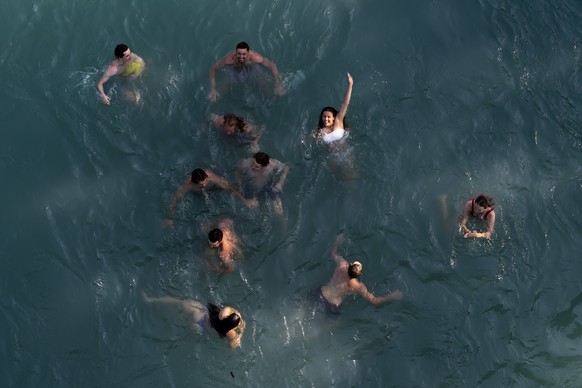 People enjoy a swim in the Aare River during the sunny and warm weather, in Bern. Switzerland, Wednesday, June 26, 2019. The forecasts predict hot weather in Switzerland with the maximum temperature a ...