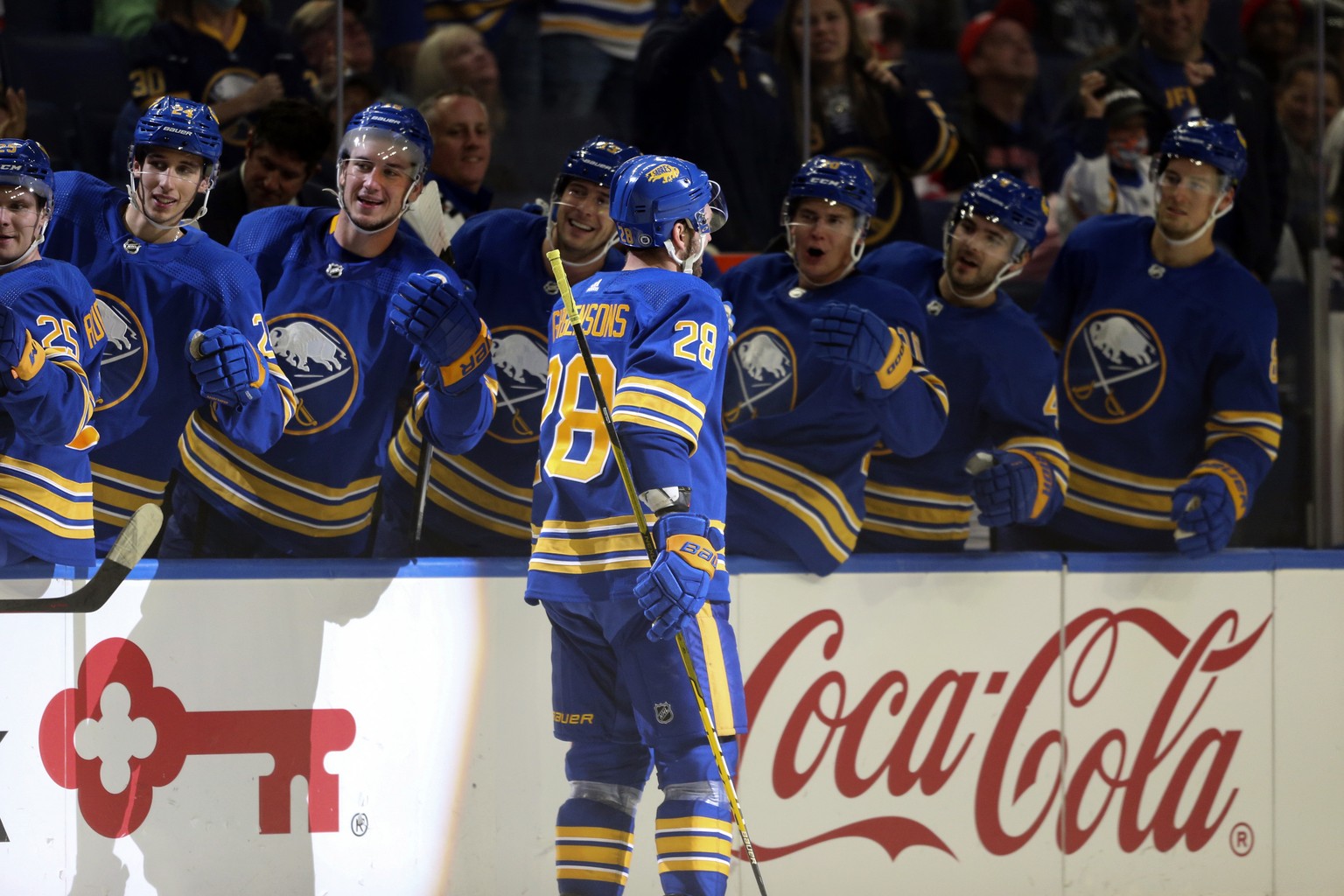Teammates congratulate Buffalo Sabres center Zemgus Girgensons (28) after his goal in the second period of a NHL preseason game against the Detroit Red Wings in Buffalo, N.Y., Saturday, Oct. 9, 2021.  ...