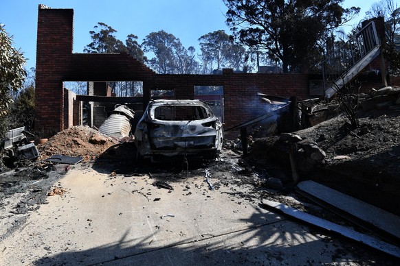 epa06613587 One of the more than 70 houses and businesses destroyed by a bushfire in the coastal town of Tathra, New South Wales, Australia, 19 March 2018. Rural Fire Service and New South Wales Fire  ...