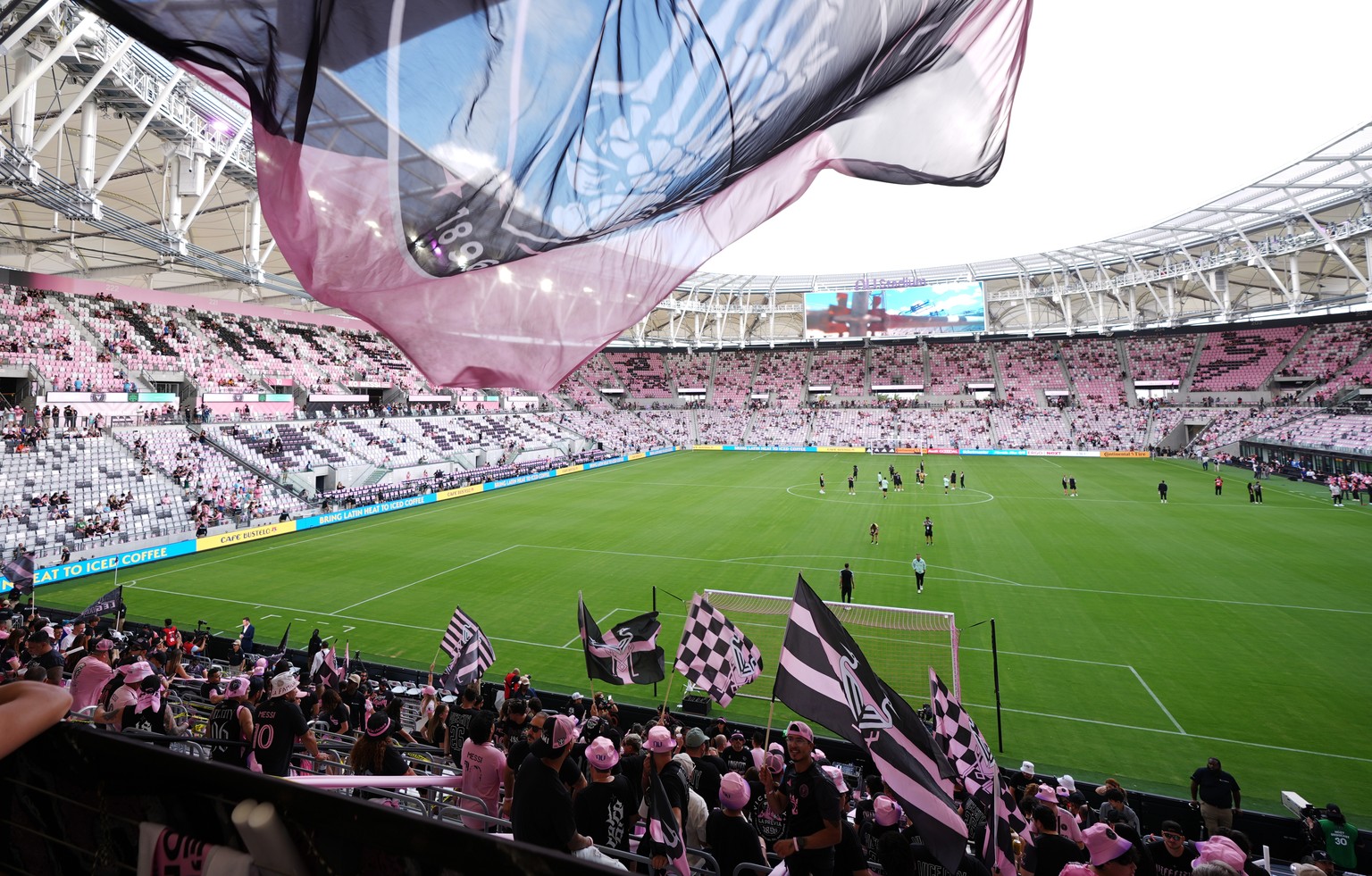 Inter Miami fans wave flags in Nu Stadium ahead of the team's first MLS soccer match in their new home stadium, against Austin FC, Saturday, April 4, 2026, in Miami. (AP Photo/Rebecca Blackwell)
 ...