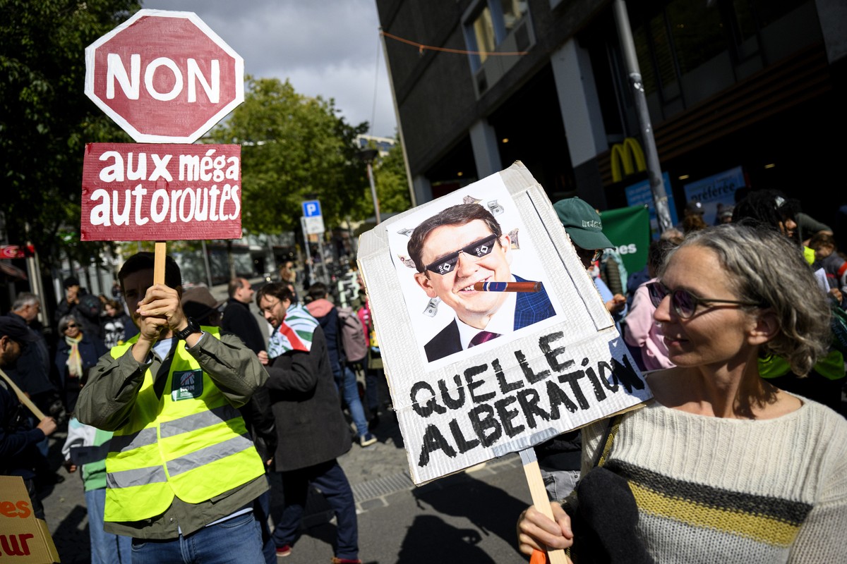 Des personnes manifestent contre les projets d'extensions d'autoroutes avec des pancartes contre le conseiller federal Albert Roesti "Quelle Alberation" ce samedi 5 octobre 2024 a  ...