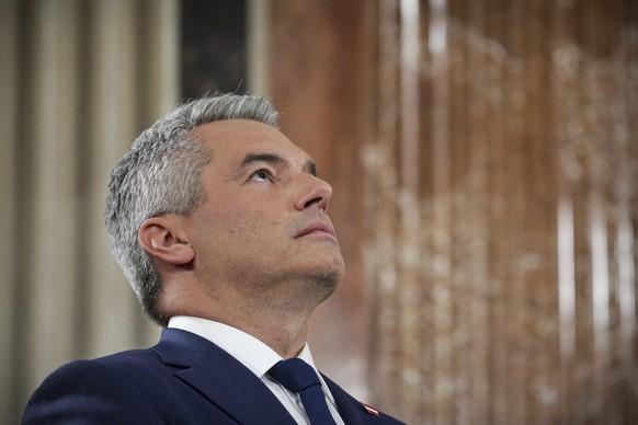 Austrian Chancellor Karl Nehammer looks up while attending a debate at the national broadcaster studio, set up in the parliament building, in Vienna, Austria, Sunday, Sept. 29, 2024, after polls close ...