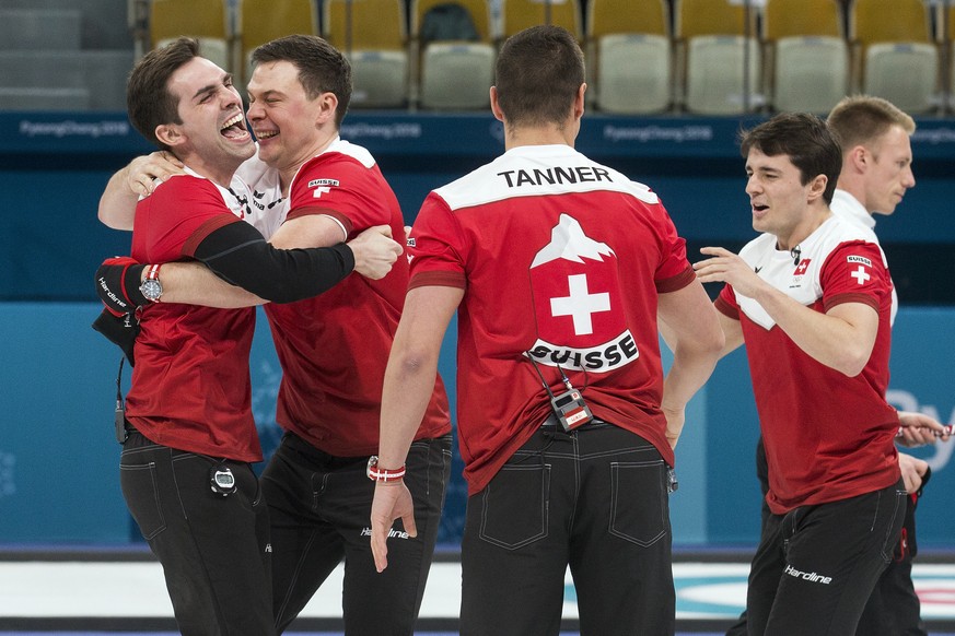 Peter de Cruz, Claudio Paetz, Valentin Tanner and Benoit Schwarz of Switzerland, from left, celebrate after winning the Curling Bronze Medal game of the men between Switzerland and Canada at the XXIII ...