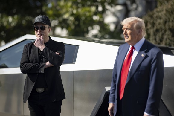 March 11, 2025, Washington, Dc, United States: U.S President Donald Trump, right, stands with billionaire Elon Musk by a Tesla Cybertruck on the South Lawn of the White House, March 11, 2025 in Washin ...