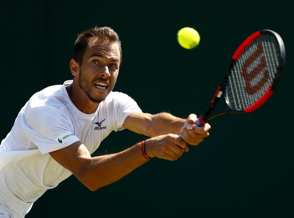 epa06067394 Lukas Rosol of Czech Republic in action against Gilles Muller of Luxembourg during their second round match for the Wimbledon Championships at the All England Lawn Tennis Club, in London,  ...