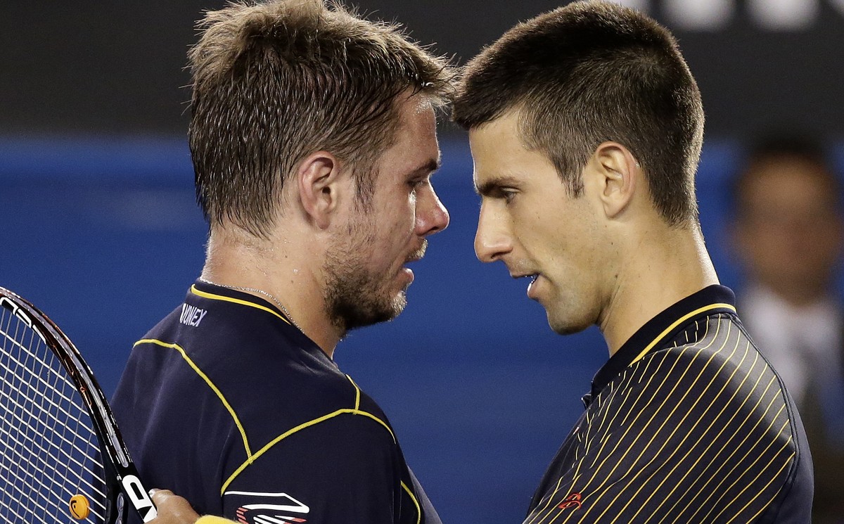Serbia's Novak Djokovic, right, embraces Switzerland's Stanislas Wawrinka after winning their fourth round match at the Australian Open tennis championship in Melbourne, Australia, Monday, J ...