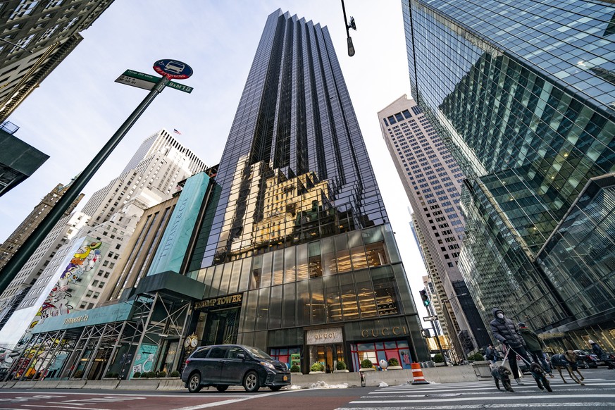 FILE - Pedestrians cross Fifth Avenue in front of Trump Tower, Wednesday, Feb. 17, 2021, in New York. The New York attorney general, Tuesday, Jan. 18, 2022, says her investigators have uncovered evide ...