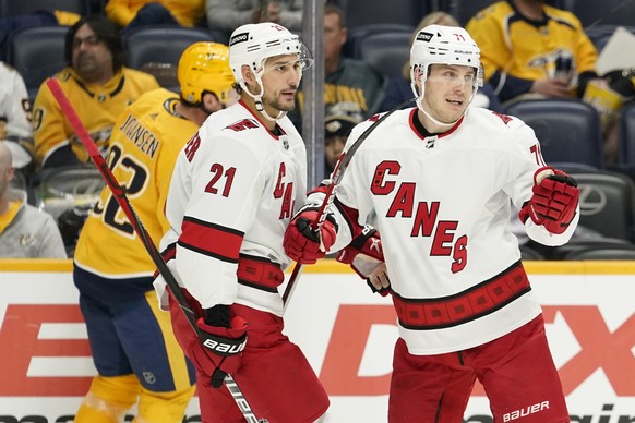 Carolina Hurricanes right wing Jesper Fast (71) celebrates with Nino Niederreiter (21) after Fast scored a goal against the Nashville Predators in the first period of an NHL hockey game Saturday, Oct. ...