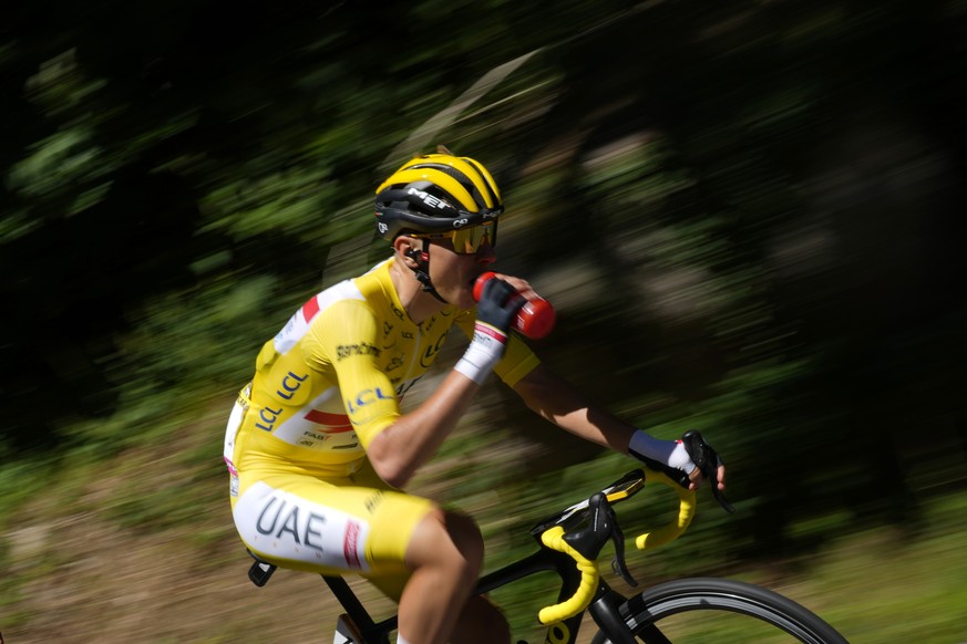 Slovenia&#039;s Tadej Pogacar, wearing the overall leader&#039;s yellow jersey drinks as he rides in the pack during the seventh stage of the Tour de France cycling race over 176.5 kilometers (109.7 m ...