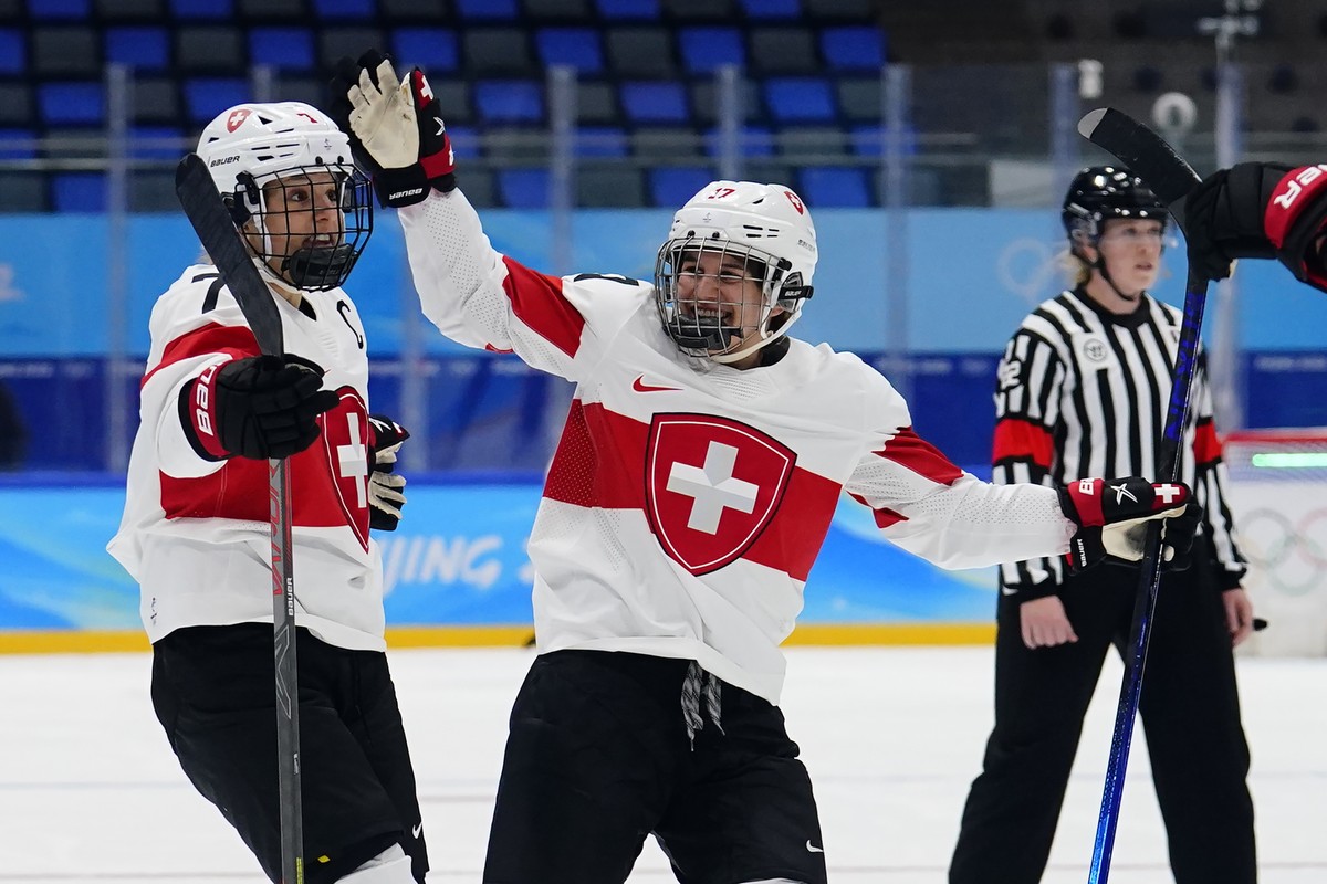Switzerland's Lara Stalder (7) is congratulated by Lara Christen (17) after Stalder scored a goal against the Russian Olympic Committee during a preliminary round women's hockey game at the  ...