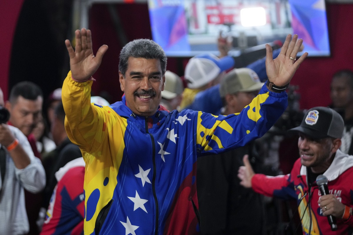 President Nicolas Maduro addresses supporters gathered outside the Miraflores presidential palace after electoral authorities declared him the winner of the presidential election in Caracas, Venezuela ...