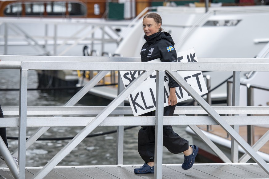 epa07800294 16-year-old climate change activist Greta Thunberg walks to a press conference from The Malizia II boat after it arrives in New York, USA 28 August 2019. Thunberg, who has inspired student ...