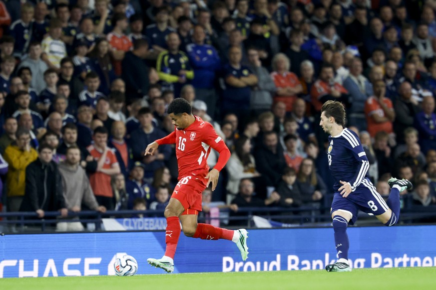 Switzerland's Zachary Athekame, left, fights for the ball against Scotland's Billy Gilmour, right, during the UEFA Nations League soccer match between Scotland and Switzerland at the Hampden ...