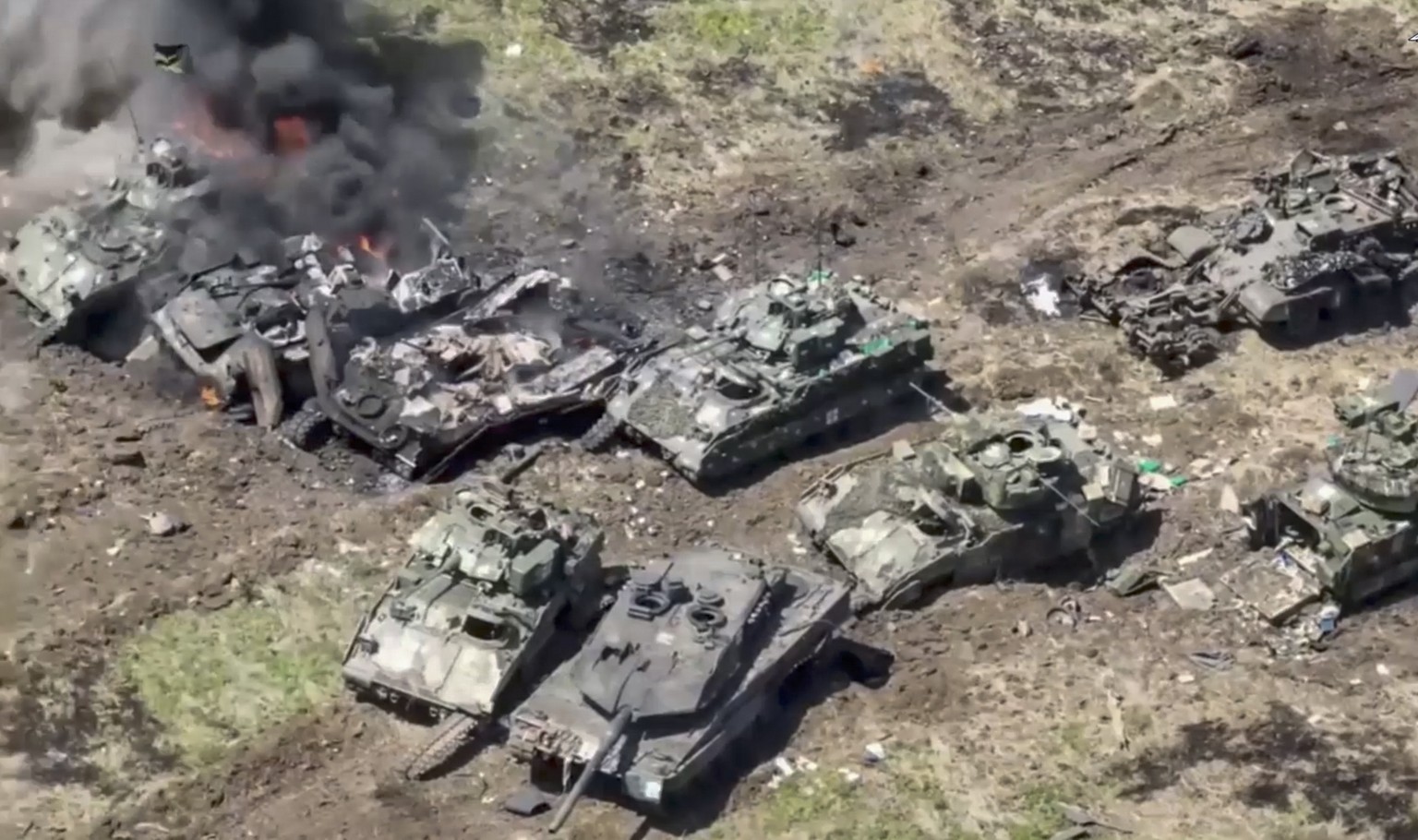 epa10683896 A handout still image taken from a handout video provided by the Russian Defence Ministry?s press service on 10 June 2023 shows German ?Leopard-2A6? and American BMP M2 ?Bradley? tanks des ...