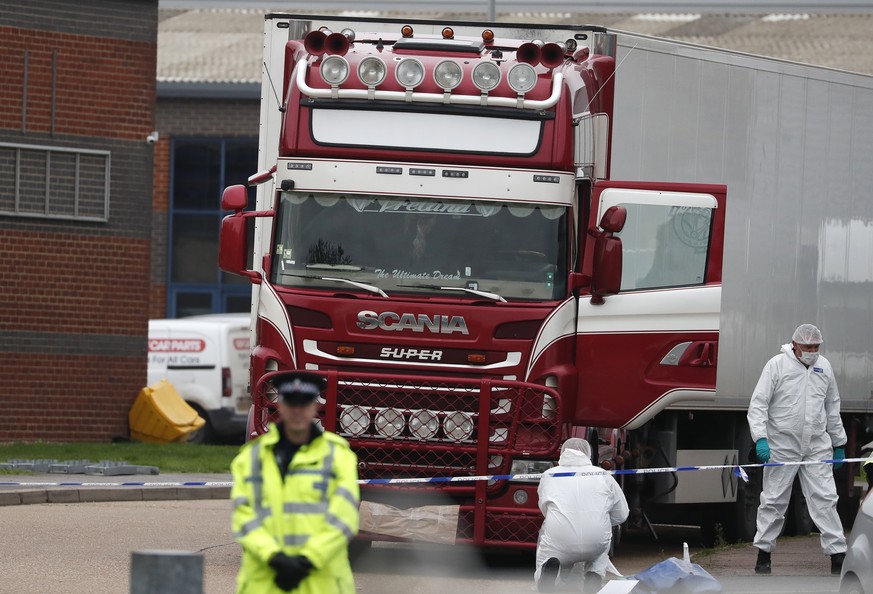 Police forensic officers attend the scene after a truck was found to contain a large number of dead bodies, in Thurrock, South England, Wednesday Oct. 23, 2019. Police in southeastern England said tha ...