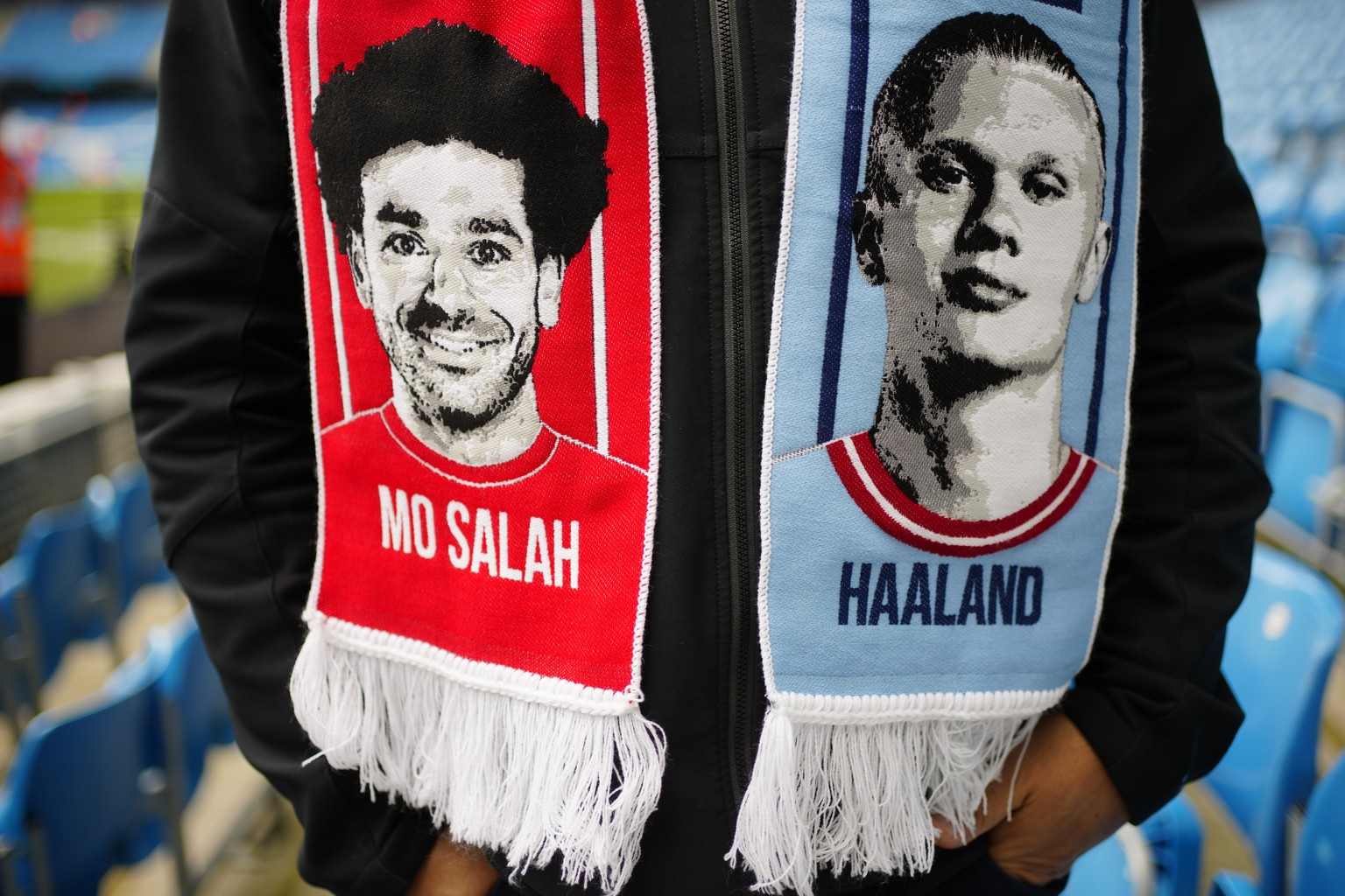 A fan wears a half and half scarf featuring Liverpool&#039;s Mohamed Salah and Manchester City&#039;s Erling Haaland prior to the English Premier League soccer match between Manchester City and Liverp ...