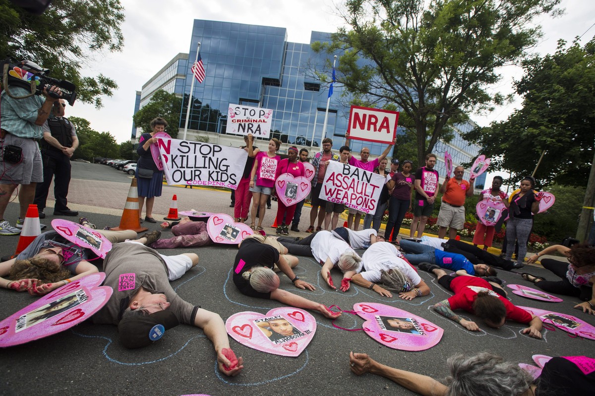 epa05381335 Demonstrators with the activist group CodePink, along with other gun control advocates, hold a 'die-in' outside the headquarters of the National Rifle Association (NRA) in Fairfa ...