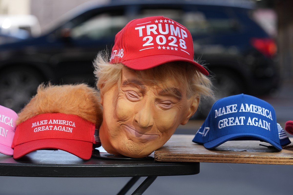 A mask with the likeness of Donald Trump is used to sell hats that read "Trump 2028" and "Make America Great Again" on the street next to the Walk of Fame star honoring Donald Trum ...