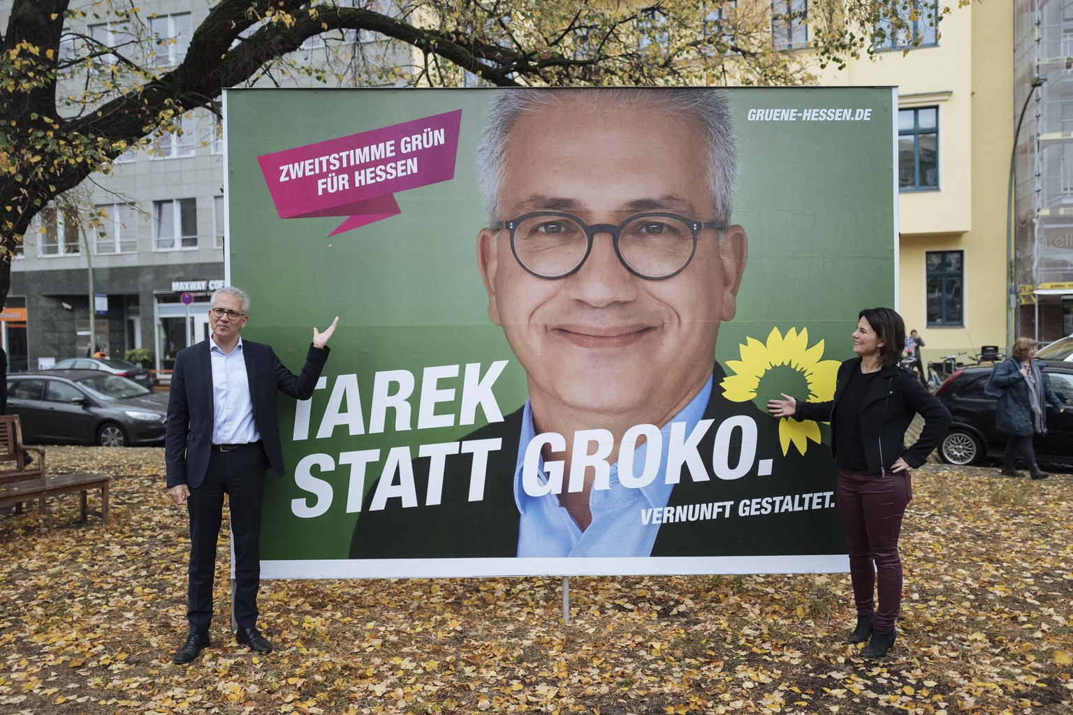 epa07111255 Leading candidate of The Greens party for the upcoming regional Hesse state elections, Tarek al-Wazir (L) shows his own campaign poster with the Greens party (Die Gruenen) co-leader Annale ...