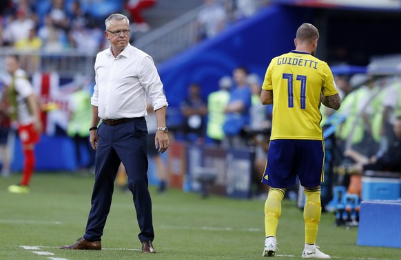 Sweden head coach Janne Andersson, left, looks his player John Guidetti during the quarterfinal match between Sweden and England at the 2018 soccer World Cup in the Samara Arena, in Samara, Russia, Sa ...