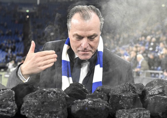 Schalke boss Clemens Toennies smells coal on a trolley beside the pitch prior the German Bundesliga soccer match between FC Schalke 04 and Bayer Leverkusen in Gelsenkirchen, Germany, Wednesday, Dec. 1 ...