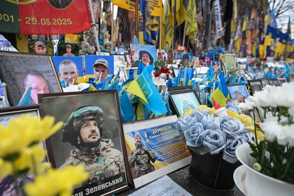 epaselect epa12773552 Portraits and flags at a memorial for the fallen Ukrainian soldiers on Independence Square in Kyiv, Ukraine, 24 February 2026. Ukraine marks the fourth anniversary since Russia b ...