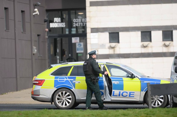 epa10485183 An officer of the Police Service of Northern Ireland (PSNI) works at the scene of a shooting at a sports complex in Omagh, County Tyrone, Northern Ireland, UK, February 23, 2023. A…