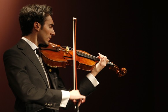 Violist David Aaron Carpenter plays the &#039;Macdonald&#039; Viola by Antonio Stradivari, made in 1719, during a presentation at Sotheby&#039;s auction house in Paris April 15, 2014. The &#039;Macdon ...