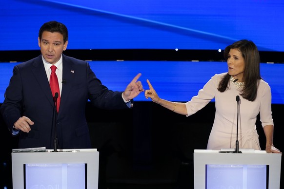 FILE - Former UN Ambassador Nikki Haley, right and Florida Gov. Ron DeSantis, left, pointing at each other during the CNN Republican presidential debate at Drake University in Des Moines, Iowa, Jan. 1 ...