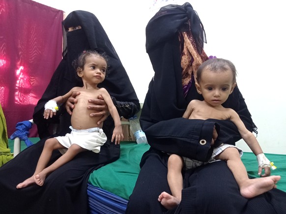 Women hold their malnourished children at Hays Rural Hospital in Hodeida, Yemen, Oct. 11, 2022. For years starvation has been an everyday threat for Yemen