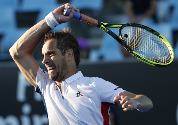 France's Richard Gasquet follows through on a shot to Italy's Lorenzo Sonego during their second round match at the Australian Open tennis championships in Melbourne, Australia, Thursday, Jan. 18, 2018. (AP Photo/Ng Han Guan)